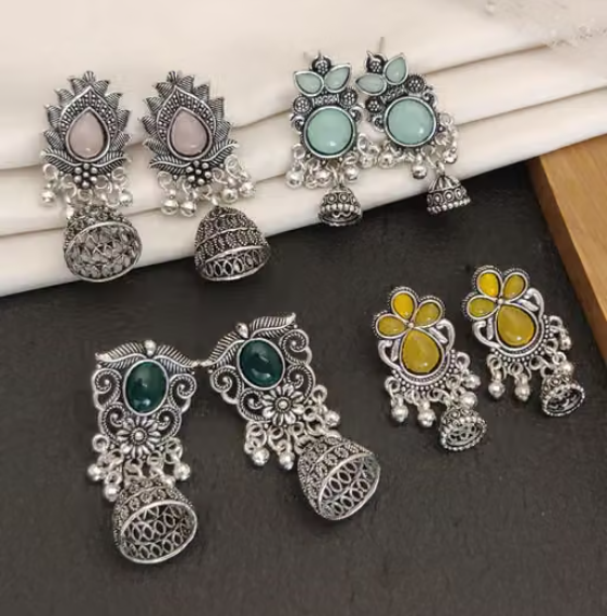 These stunning oxidized silver jhumkas feature vibrant red, green, and pink hues, perfect for festive occasions. Their intricate designs complement any outfit, adding a touch of elegance and tradition,