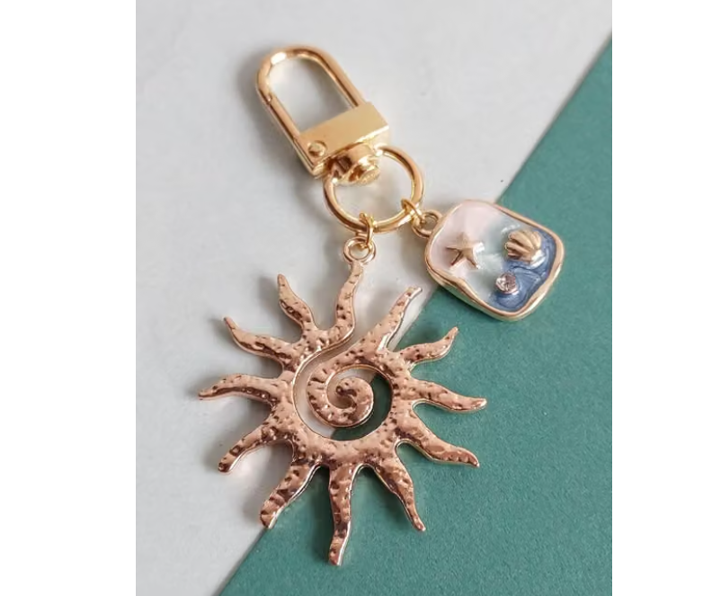 Golden Sun Bag Charm, Zipper Pull, Bag Clip Pearl Clear Phone Case + Pearls Wristlet | Phone Charms | iPhone Cases